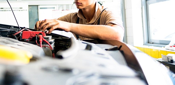 Mechanic-Inspecting-Car-Battery